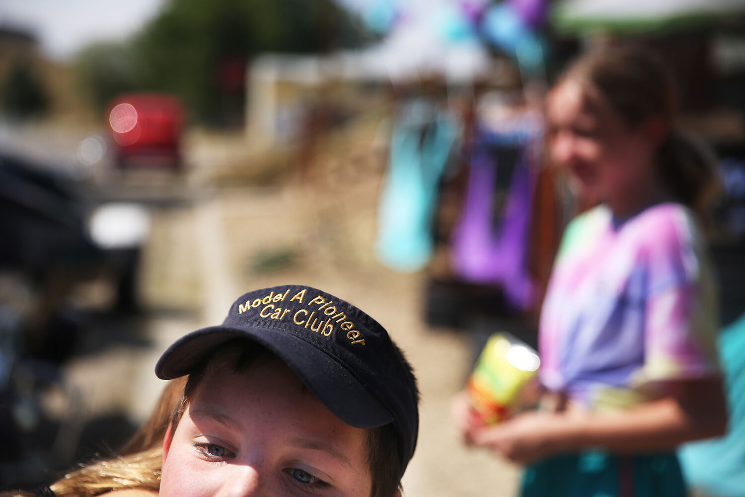 Lane O’Neil hugs his sister while wearing his new car club visor